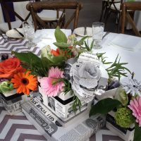 A nod to the newspaper connection with a mixture of paper flowers and fresh blooms.